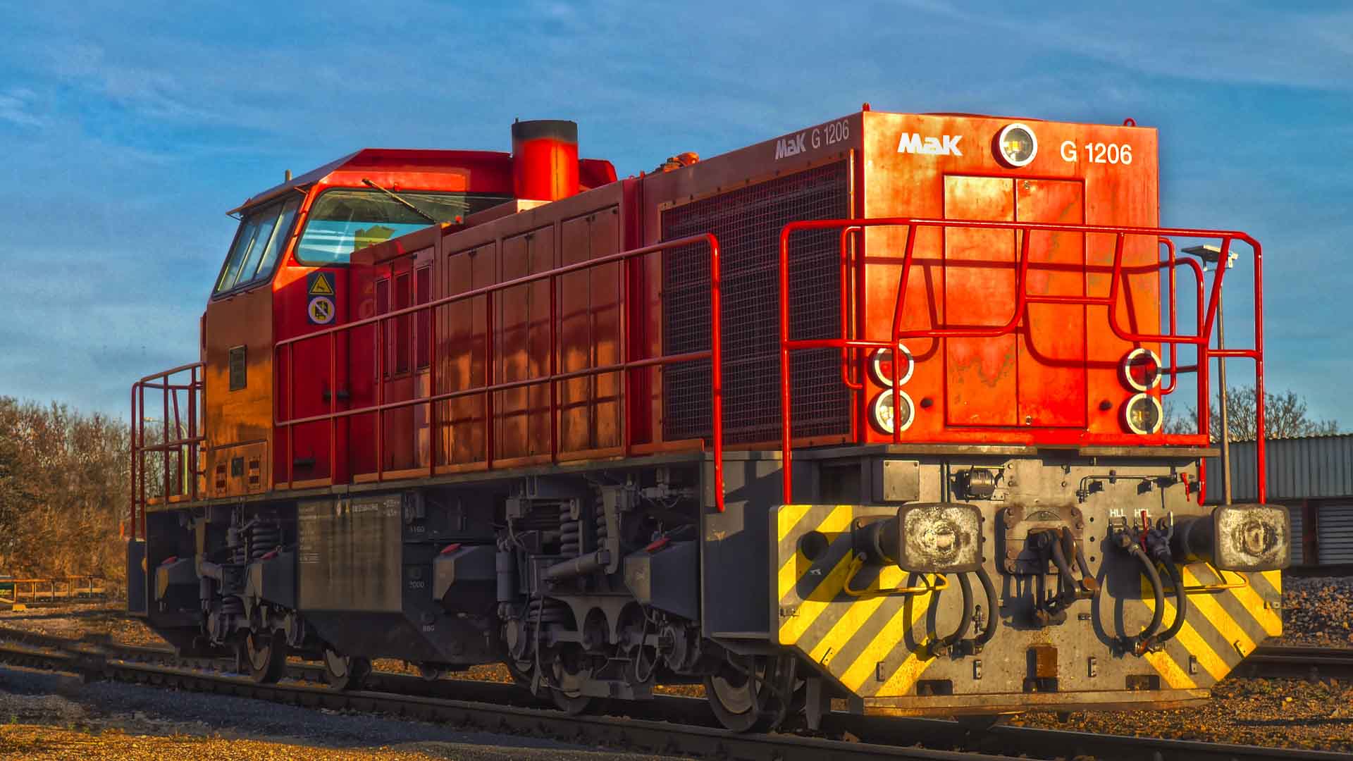 A vibrante locomotiva a diesel vermelha com número 1206 brilha sob o céu diurno, um símbolo marcante da capacidade de importação no mercado de inovações ferroviárias.